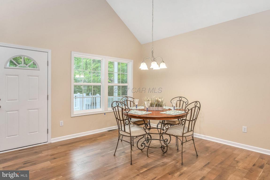 173 Sandyhook Road Ocean Pines, MD 21811 - Photo 7 of 40 a view of a dining room with furniture window and wooden floor