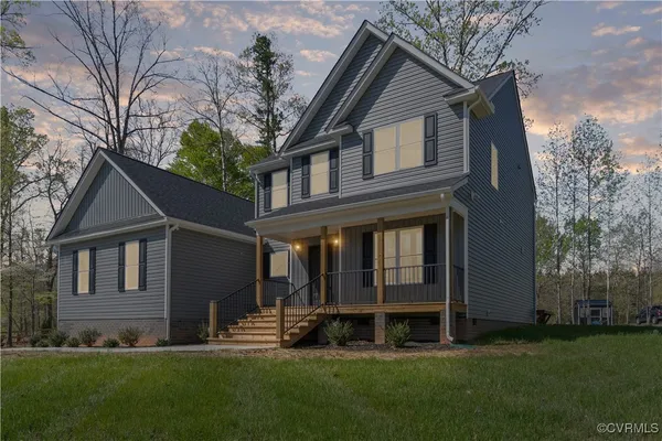 a front view of a house with a yard and porch