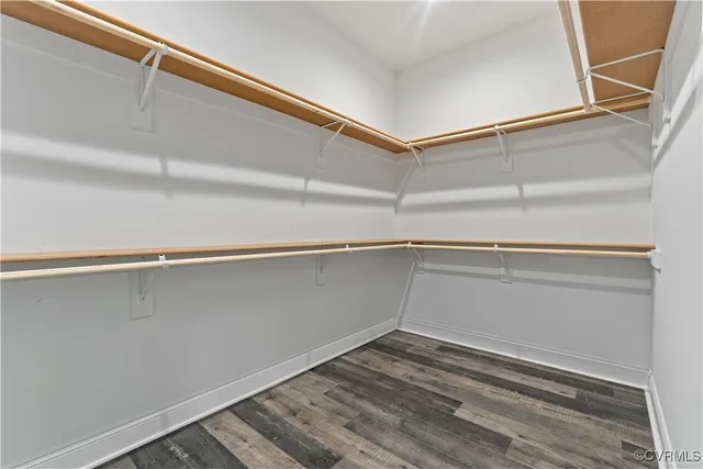 a bathroom with a double vanity sink and mirror with toilet