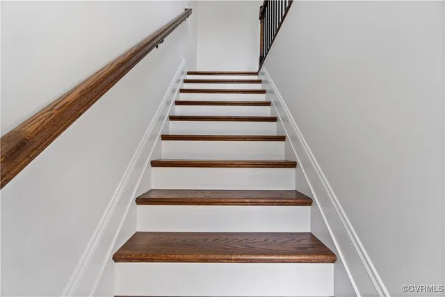 a view of a room with wooden floor and a ceiling fan