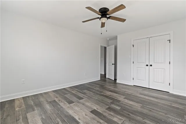 a bathroom with a granite countertop sink a toilet and a mirror