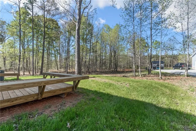 a view of a house with a yard and sitting area