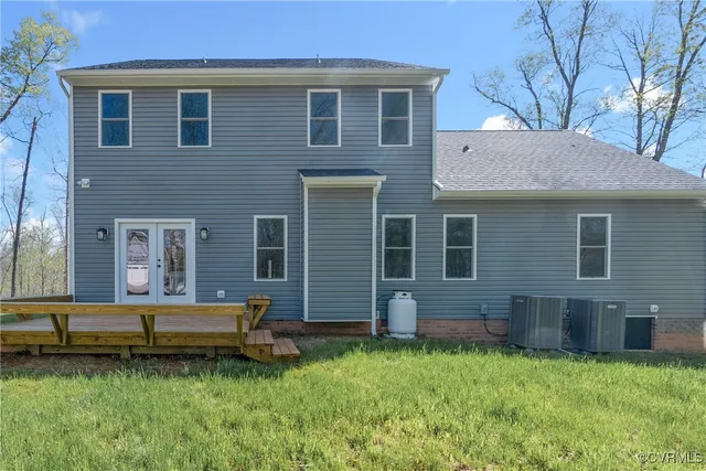 a view of a house with a yard and sitting area