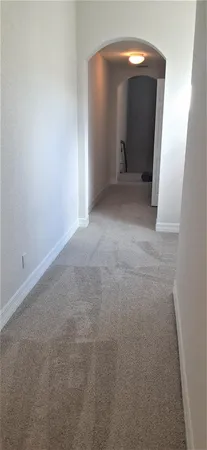 an empty room with a ceiling fan and window