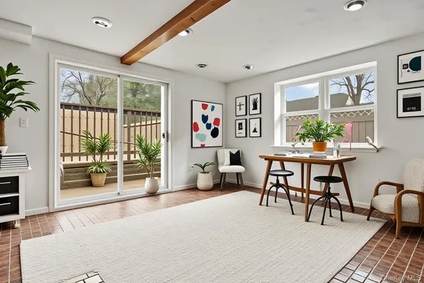 a living room with furniture and a potted plant