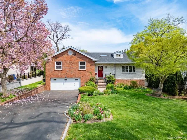 a front view of house with yard and green space