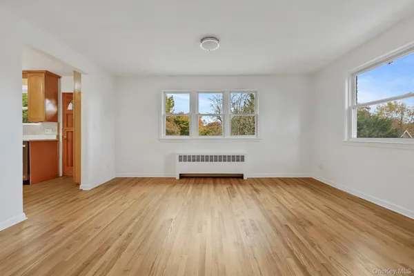 an empty room with windows and closet