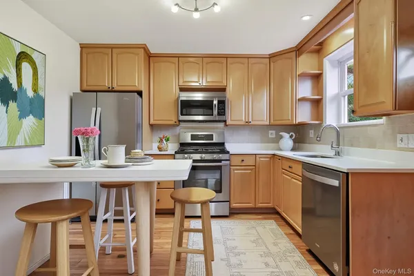 a kitchen with a stove a sink and a refrigerator