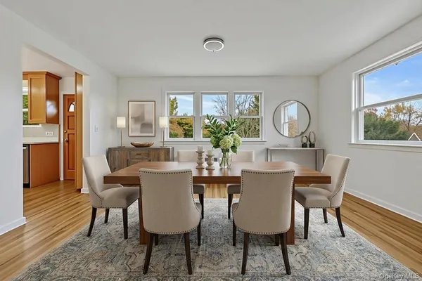 a view of a dining room with furniture window and wooden floor