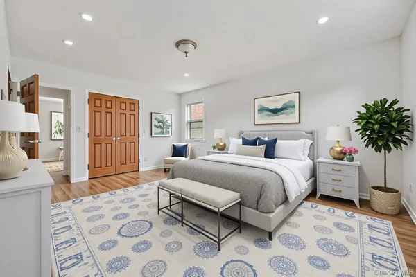 a spacious bedroom with a bed a couch and a window