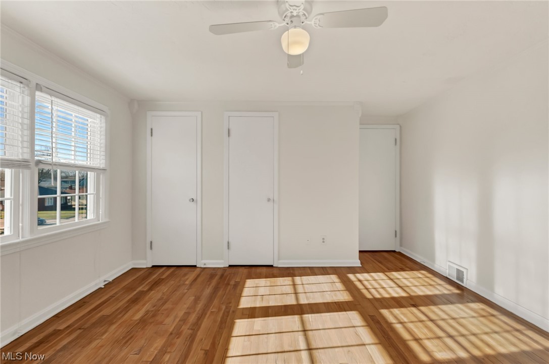 9516 Snow Road Cleveland, OH 44130 - Photo 29 of 40 Bedroom with light hardwood / wood-style flooring, multiple closets, and ceiling fan