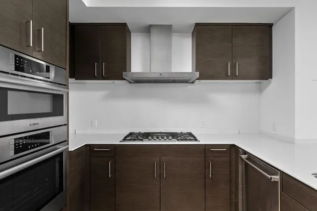 a room with furniture and view of kitchen