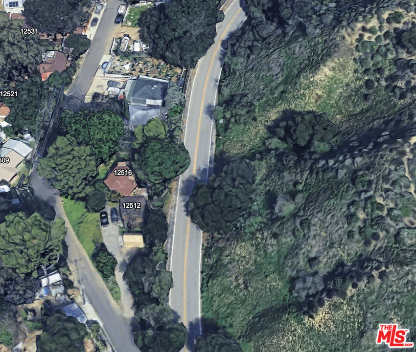12500 Kagel Canyon Road Sylmar, CA 91342 - Photo 4 of 8 a aerial view of a house with a yard and large trees