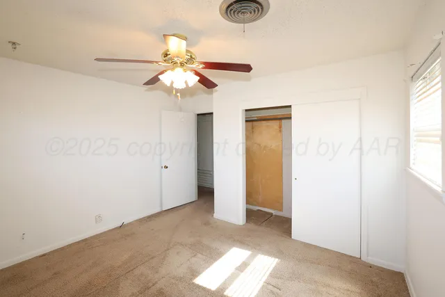 a view of a chandelier fan and a window