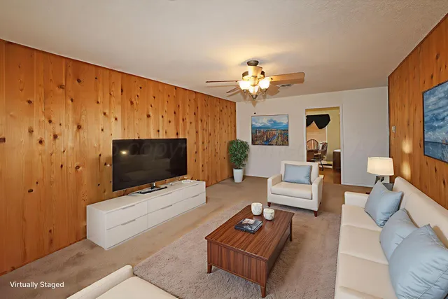 a living room with furniture a dining table and a flat screen tv