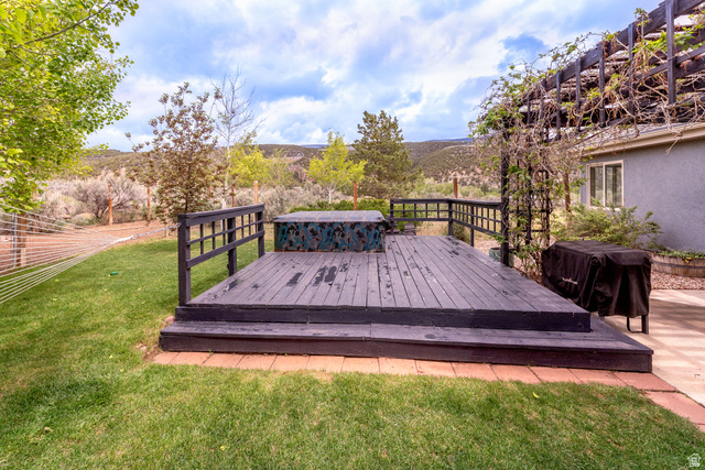 7343 North Sawtooth Cv Road Vernal, UT 84078 - Photo 29 of 64 Expansive wooden deck with railing and hot tub