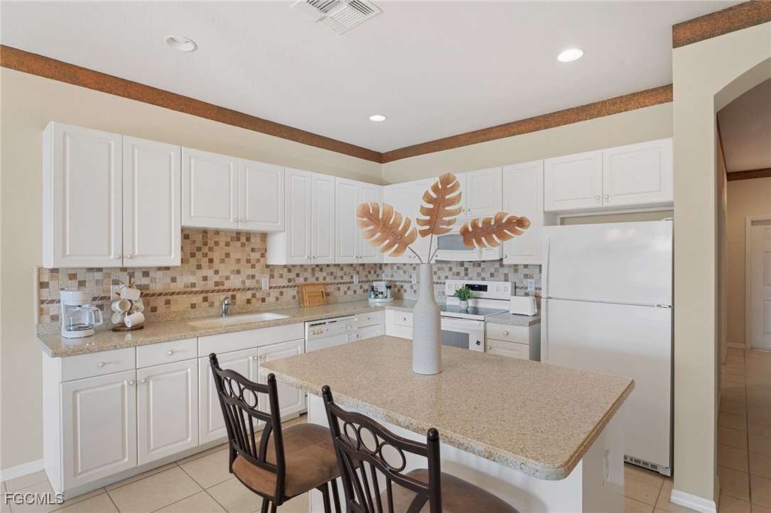 14981 Reflection Key Circle, Unit 335 Fort Myers, FL 33907 - Photo 12 of 42 a kitchen with a table and chairs in it