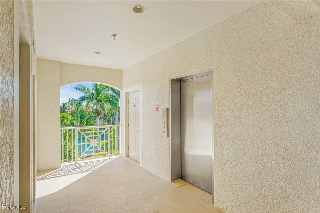14981 Reflection Key Circle, Unit 335 Fort Myers, FL 33907 - Photo 30 of 42 a view of a big room with a large window and front door