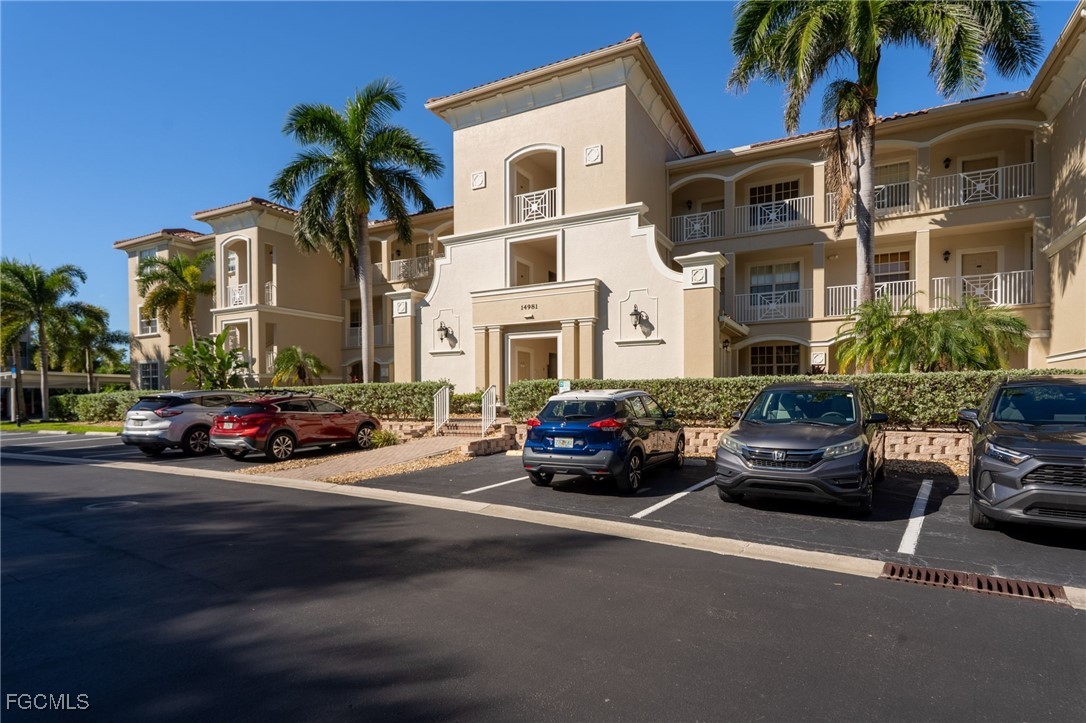 14981 Reflection Key Circle, Unit 335 Fort Myers, FL 33907 - Photo 3 of 42 a view of a cars parked in front of a building