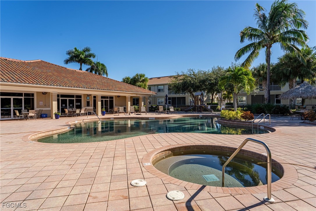 14981 Reflection Key Circle, Unit 335 Fort Myers, FL 33907 - Photo 33 of 42 a front view of a house with swimming pool having outdoor seating