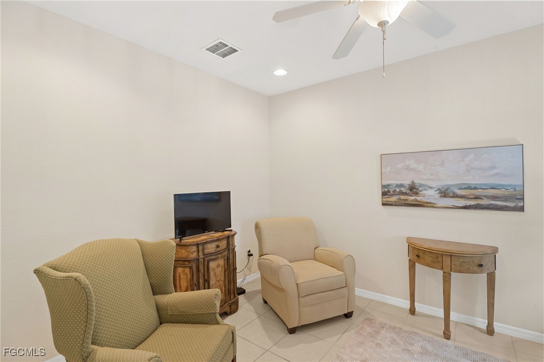 14981 Reflection Key Circle, Unit 335 Fort Myers, FL 33907 - Photo 8 of 42 a living room with furniture and a flat screen tv