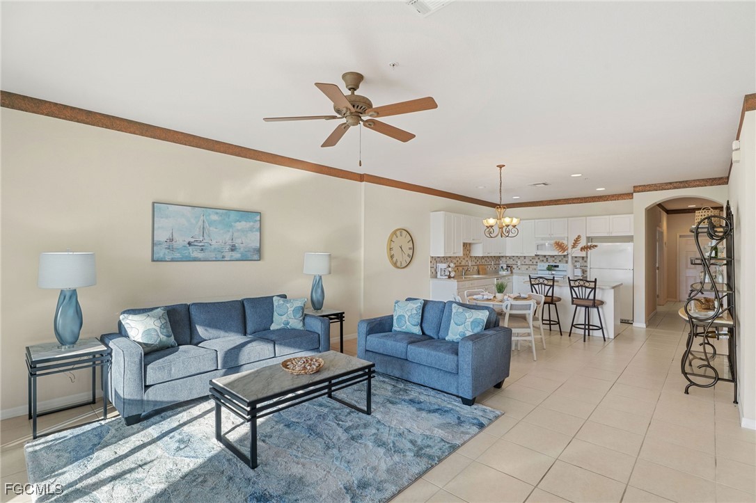 14981 Reflection Key Circle, Unit 335 Fort Myers, FL 33907 - Photo 10 of 42 a living room with furniture and a clock