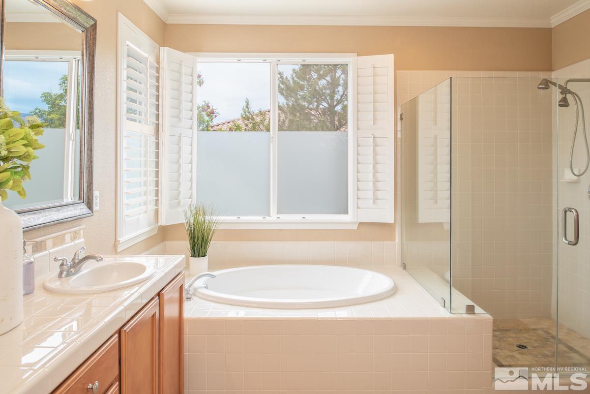 410 Shire Court Reno, NV 89521 - Photo 17 of 40 a bathroom with a granite countertop sink and a mirror