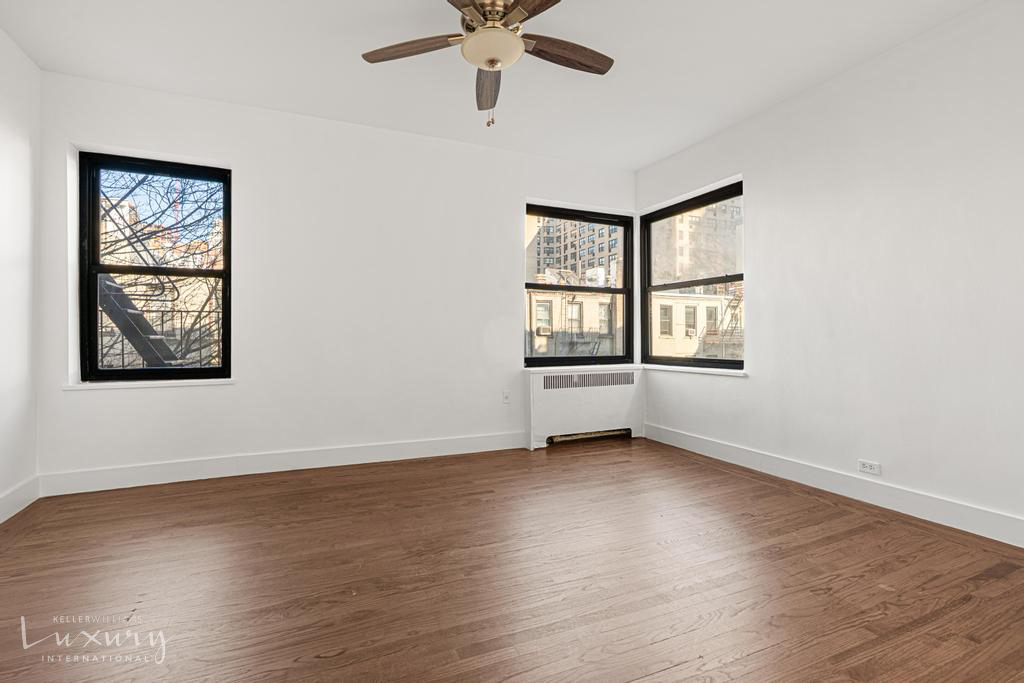 Undisclosed Address Manhattan, NY 10021 - Photo 8 of 15 a view of an empty room with a window and wooden floor