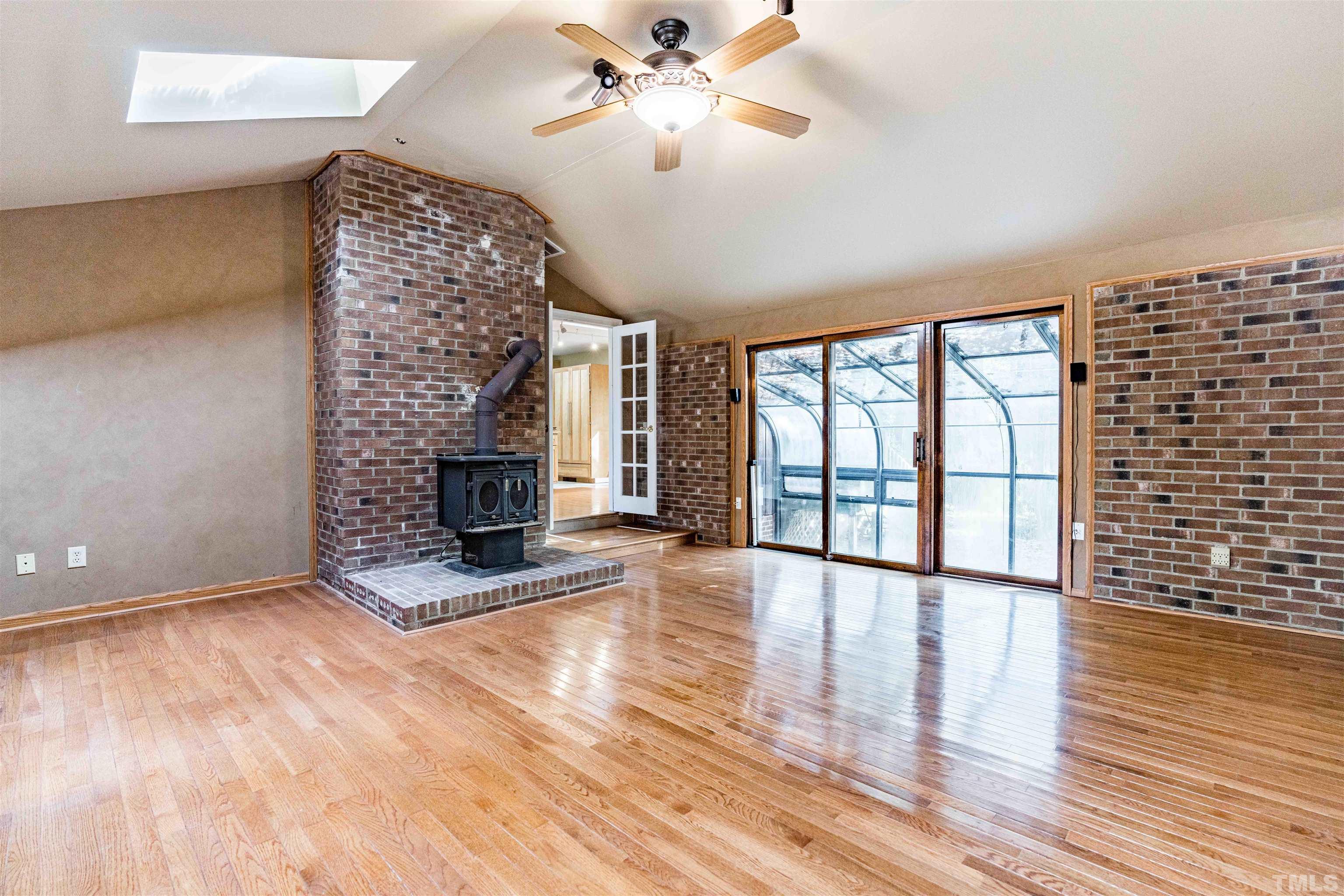 3105 Rutledge Court Raleigh, NC 27613 - Photo 21 of 48 a view of an empty room with a fireplace and wooden floor