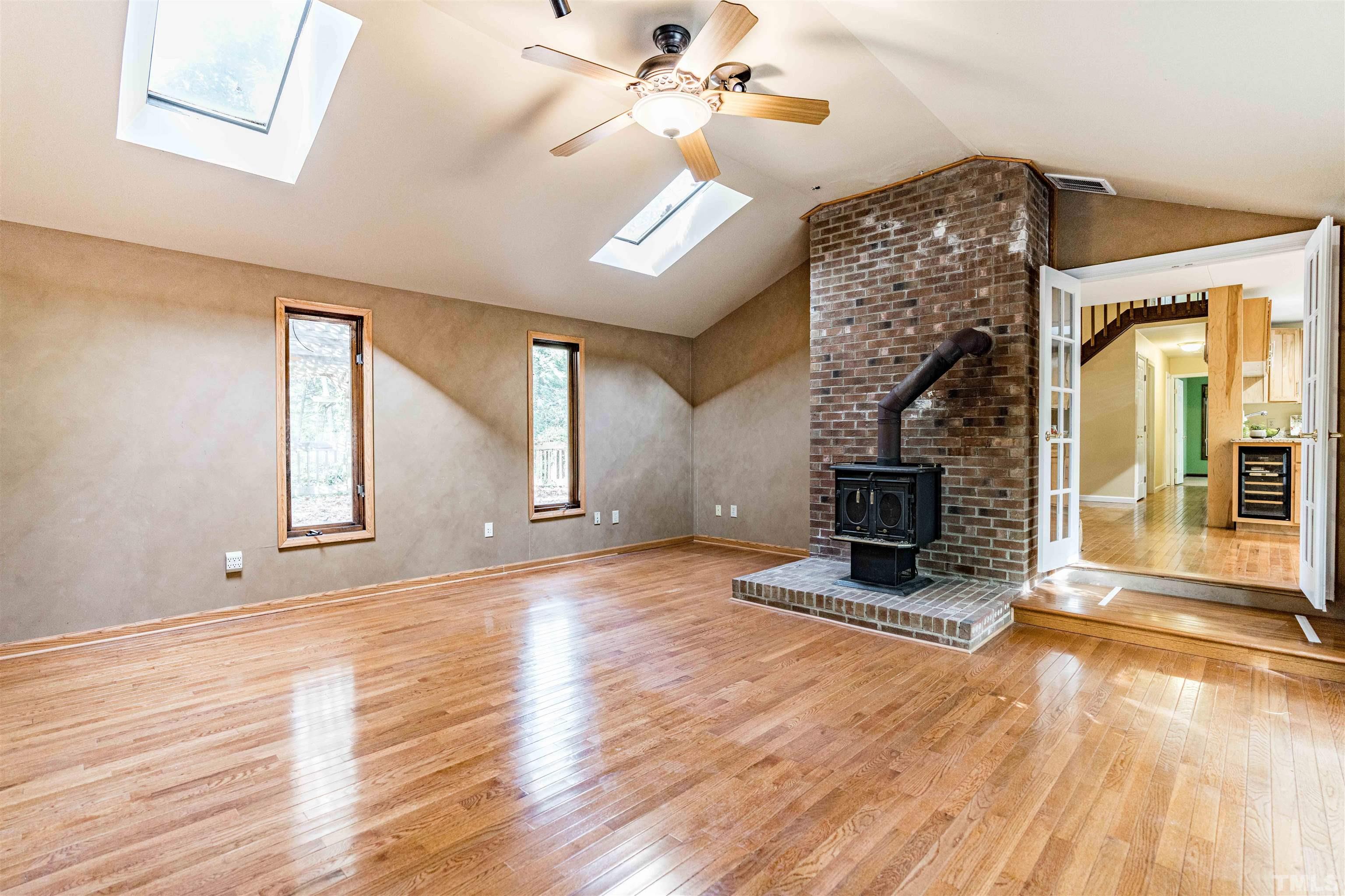 3105 Rutledge Court Raleigh, NC 27613 - Photo 22 of 48 wooden floor fireplace and windows in a room