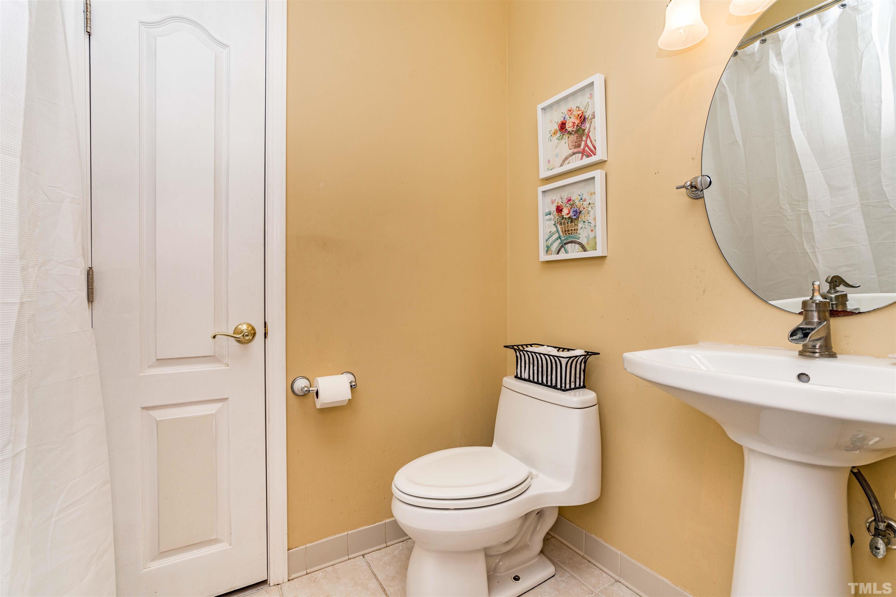 3105 Rutledge Court Raleigh, NC 27613 - Photo 28 of 48 a bathroom with a toilet sink and mirror