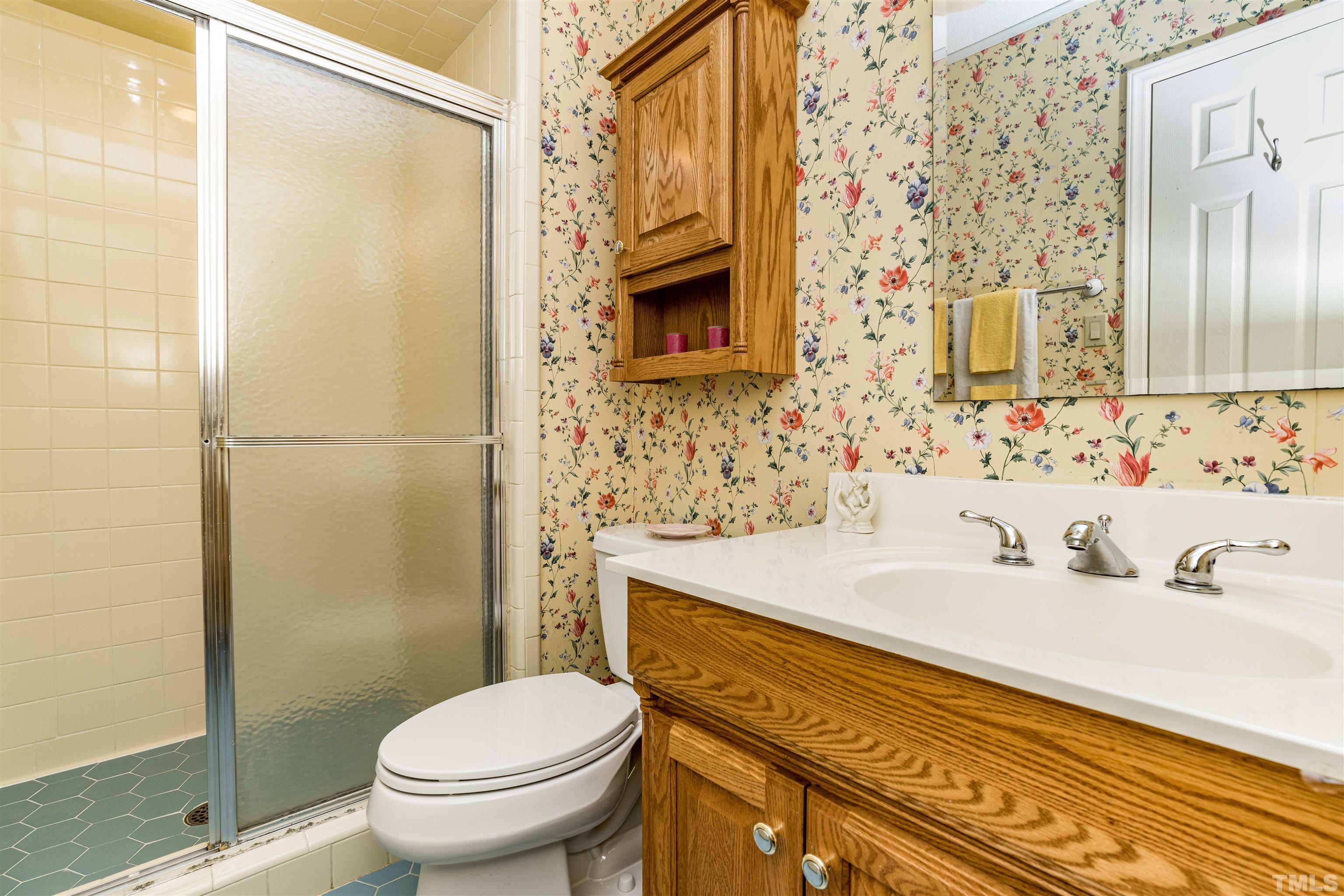 3105 Rutledge Court Raleigh, NC 27613 - Photo 33 of 48 a bathroom with a sink a toilet and shower
