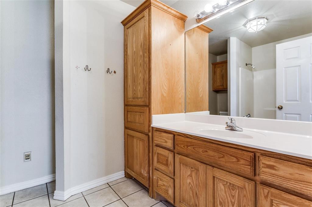 1008 Treys Court Sanger, TX 76266 - Photo 15 of 17 Full Master bathroom featuring vanity, light tile patterned floors, and a shower