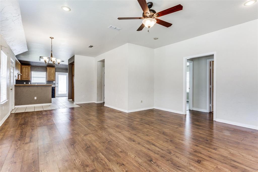 1008 Treys Court Sanger, TX 76266 - Photo 6 of 17 Unfurnished living room featuring a chandelier, dark wood finished floors, recessed lighting, and a ceiling fan