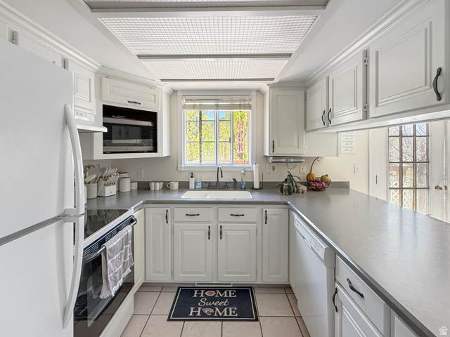 1716 Sagewood Road Price, UT 84501 - Photo 11 of 73 Kitchen with white appliances, white cabinetry, and light tile patterned flooring