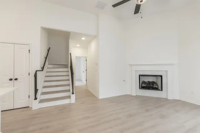 a view of a livingroom with a fireplace and stairs