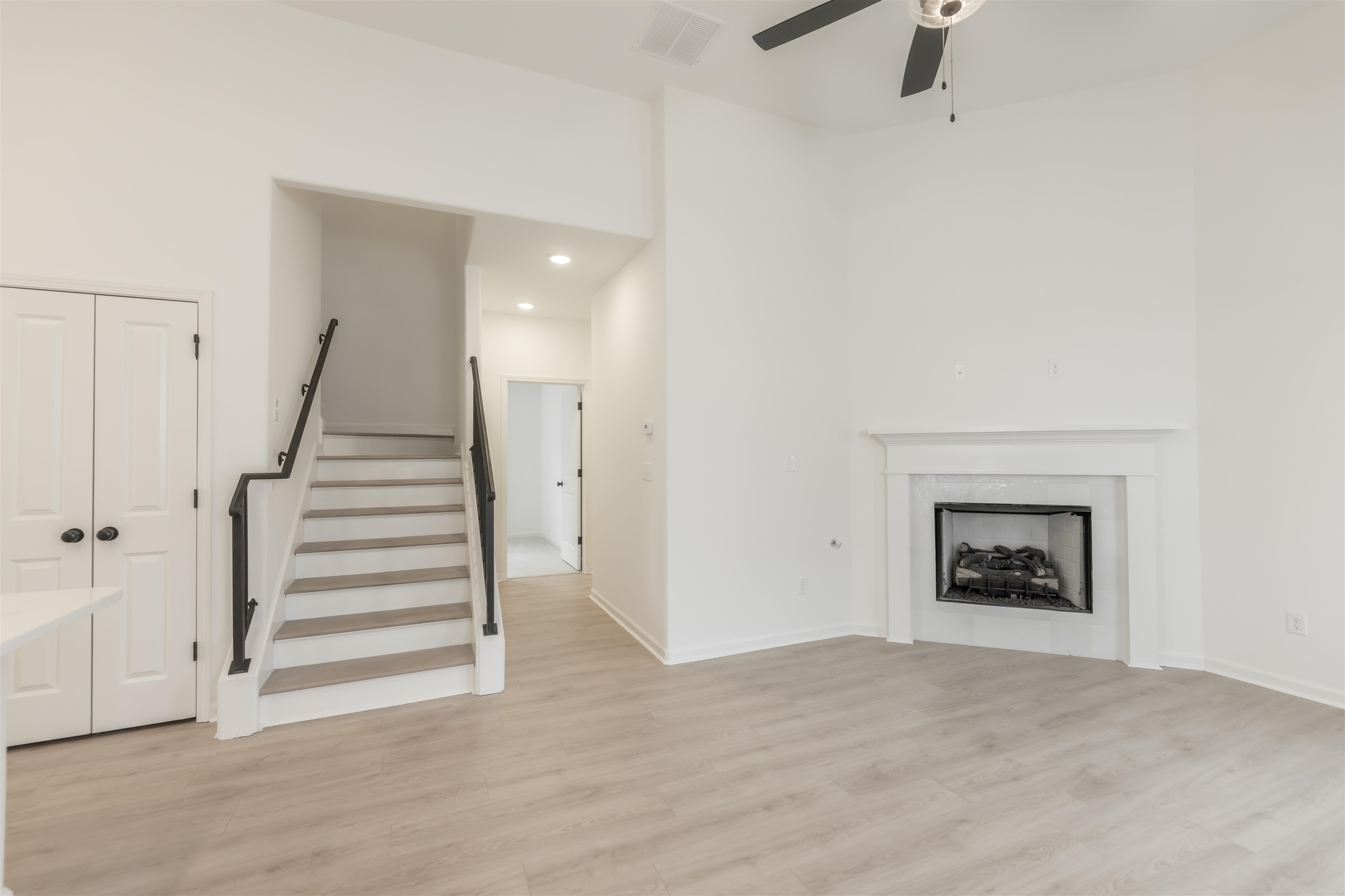 22 Doral Loop Oakland, TN 38060 - Photo 3 of 27 a view of a livingroom with a fireplace and stairs