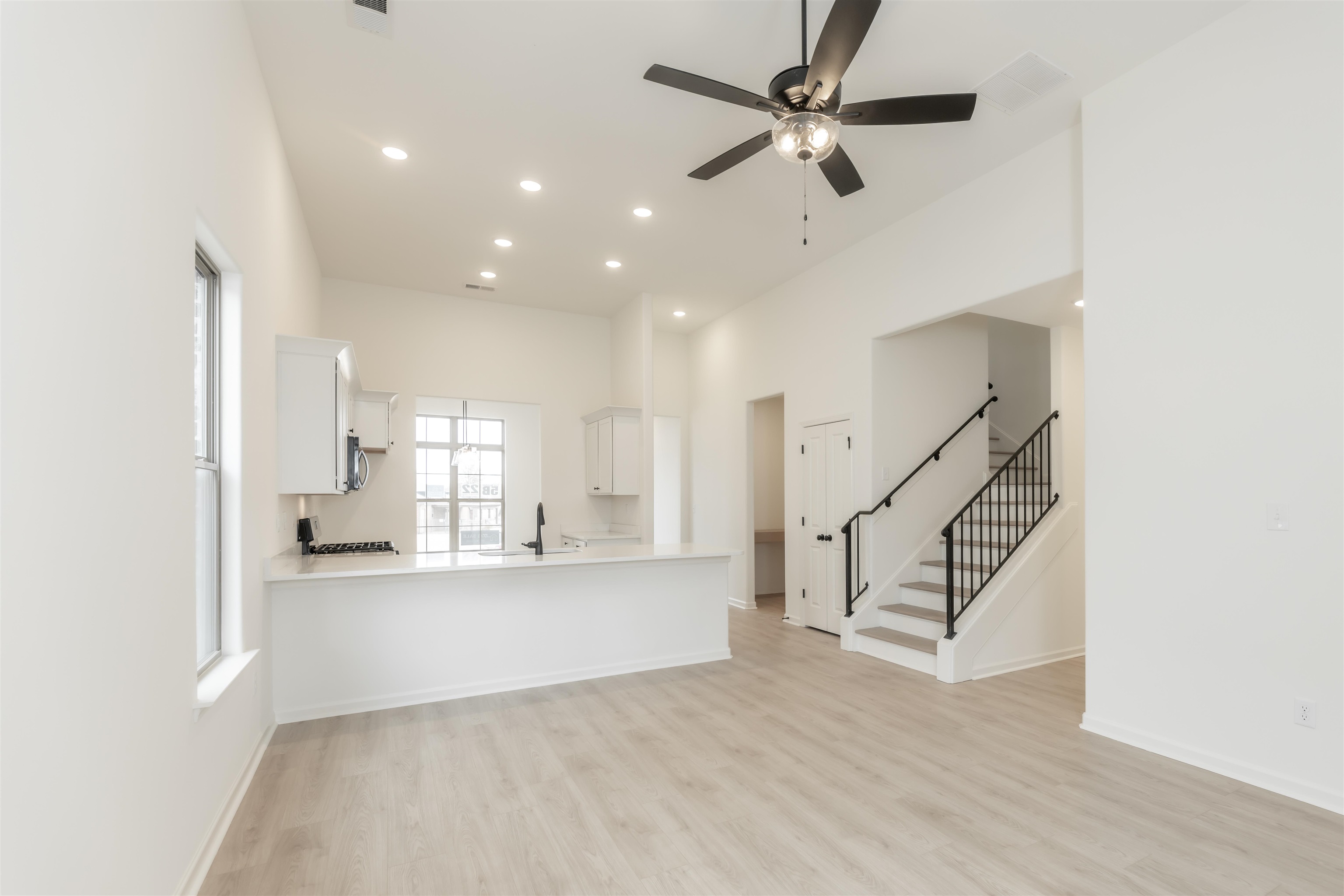 22 Doral Loop Oakland, TN 38060 - Photo 5 of 27 a view of a kitchen with wooden floor and a ceiling fan