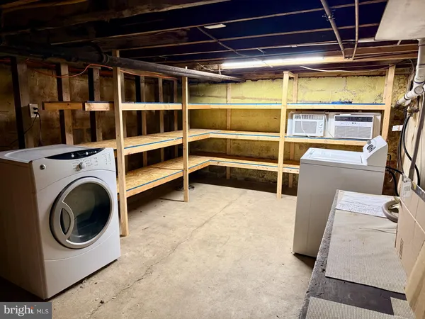 a view of storage and utility room with washer and dryer