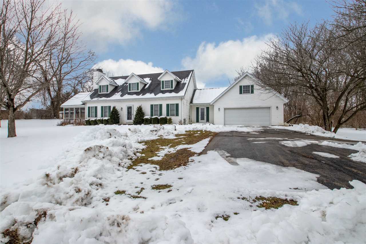 6526 North Marrill Road Byron, IL 61010 - Photo 3 of 25 a view of a white house with a yard covered in snow