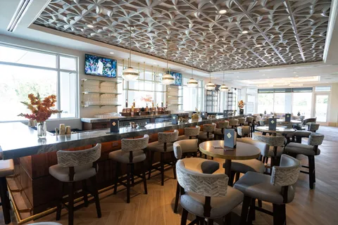 a lobby with furniture and floor to ceiling window