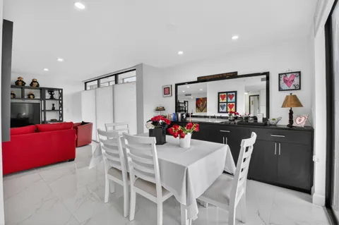 a kitchen with a sink and chairs