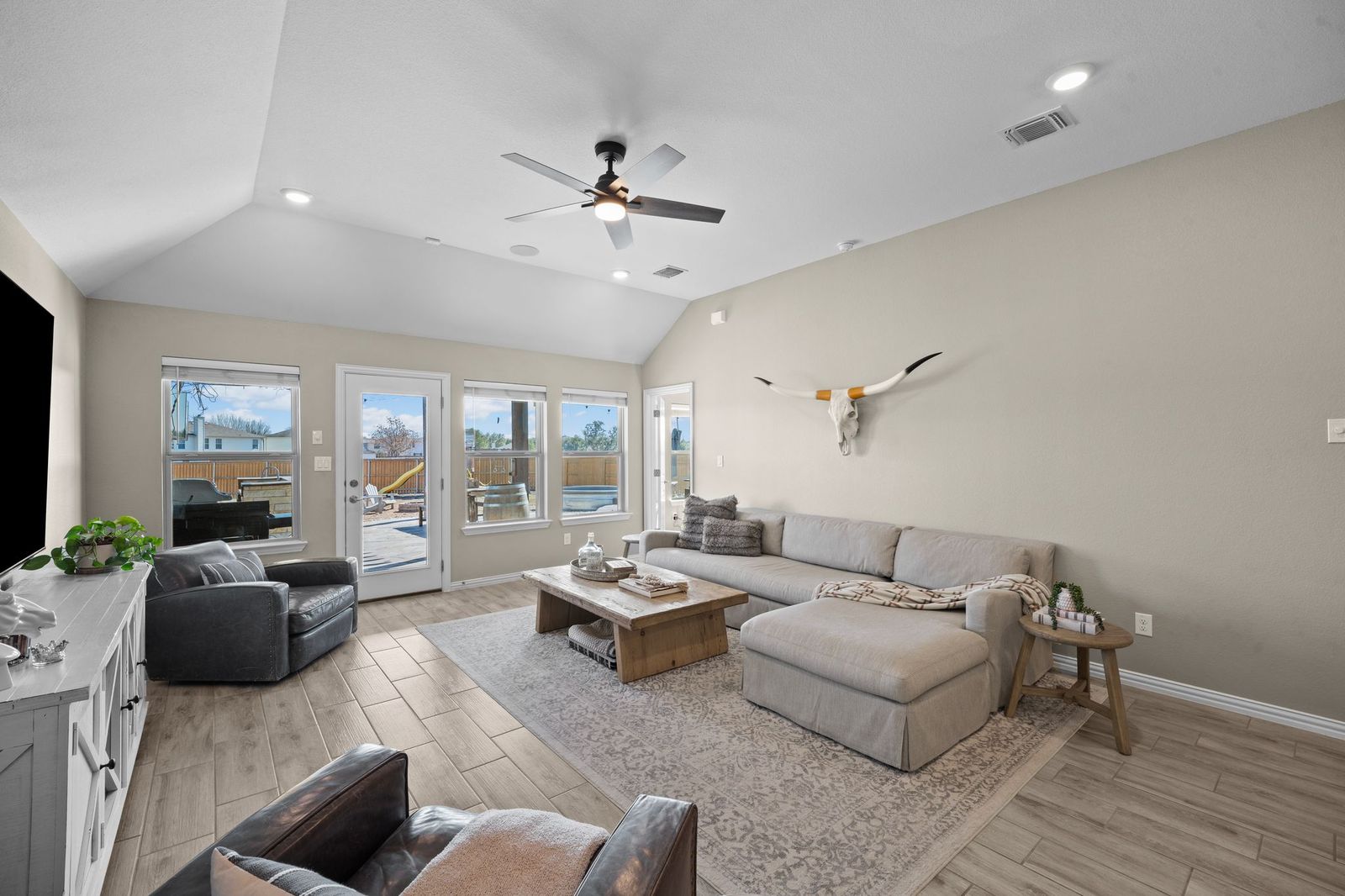 529 Cold Riv Run Kyle, TX 78640 - Photo 13 of 39 The living room is very relaxing with plenty of space to entertain the family! Comes equipped with recessed lighting, surround sound, ceiling fan, and wood like luxury tile flooring!
