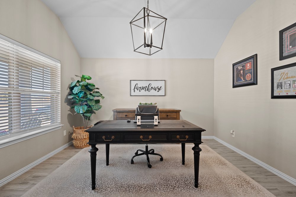 529 Cold Riv Run Kyle, TX 78640 - Photo 17 of 39 This area is currently being used as an office but could be used as a 4th bedroom, if needed. This room is decorated with barn doors, a centered pendant light fixture, and wood look tile flooring.