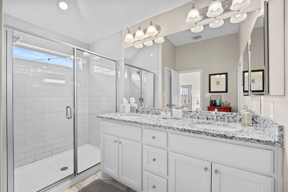 529 Cold Riv Run Kyle, TX 78640 - Photo 21 of 39 This spacious master bath comes with gorgeous granite countertops (same as kitchen), dual vanities, and a spacious stand-up shower w/ a transom window. The transom window allows a good amount of natural light in this area, without sacrificing privacy.