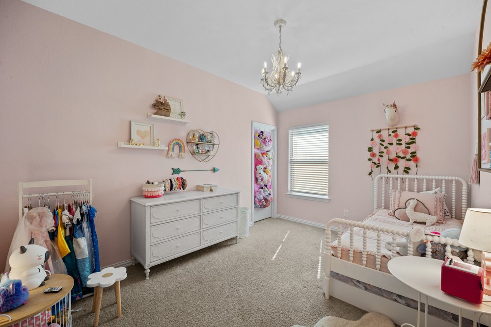 529 Cold Riv Run Kyle, TX 78640 - Photo 24 of 39 I think we all know whose bedroom this belongs to! The professional paint decor and charming chandelier give this space plenty of personality, making it a perfect fit for any of the girls in the family. No girls in the family, you say? No big deal at all. A fresh coat of paint and swapping the chandelier for a ceiling fan easily transforms this room into a boy’s bedroom or a welcoming guest space. Easy peasy!