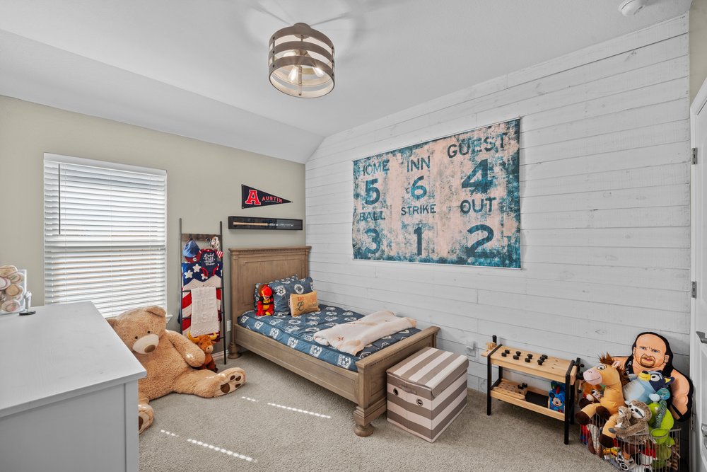 529 Cold Riv Run Kyle, TX 78640 - Photo 26 of 39 I think we all know whose bedroom this belongs to as well! The professional paint decor, shiplap walls, and hanging light fixture give this space tons of personality. It’s a perfect fit for any of the boys in the family. If needed, this room can easily be decorated to suit any style or vision you have in mind.