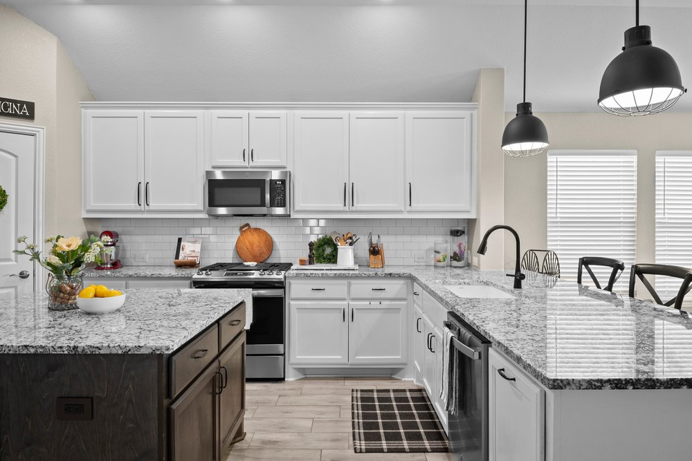 529 Cold Riv Run Kyle, TX 78640 - Photo 8 of 39 The kitchen features gorgeous granite counter tops, classic subway backsplash, stainless steel appliances, a pull in breakfast bar area, hanging pendant light fixtures, recessed lighting, hardware throughout, and a functional center island.