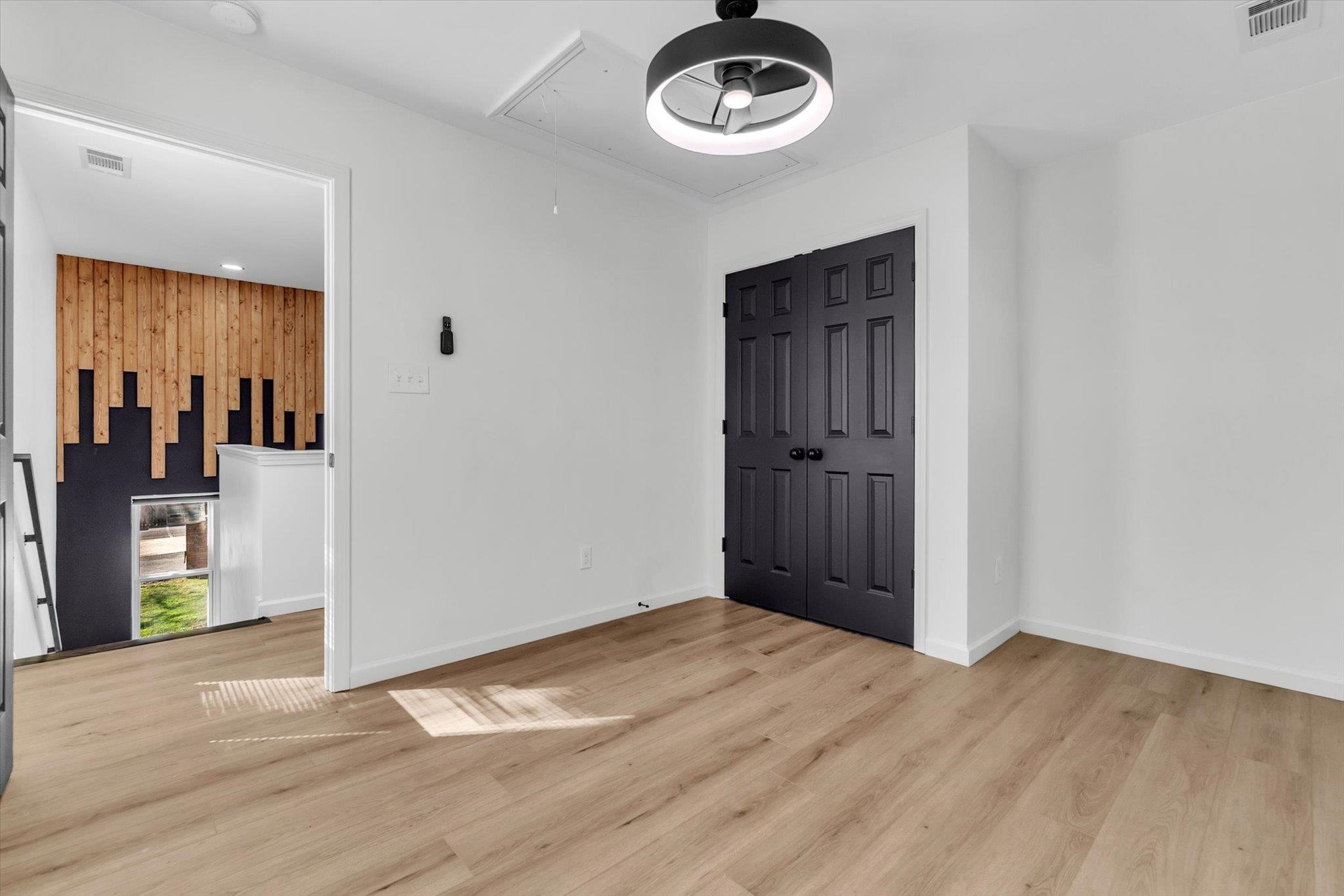 574 Lipford Street Memphis, TN 38112 - Photo 15 of 26 an empty room with a door and wooden floor
