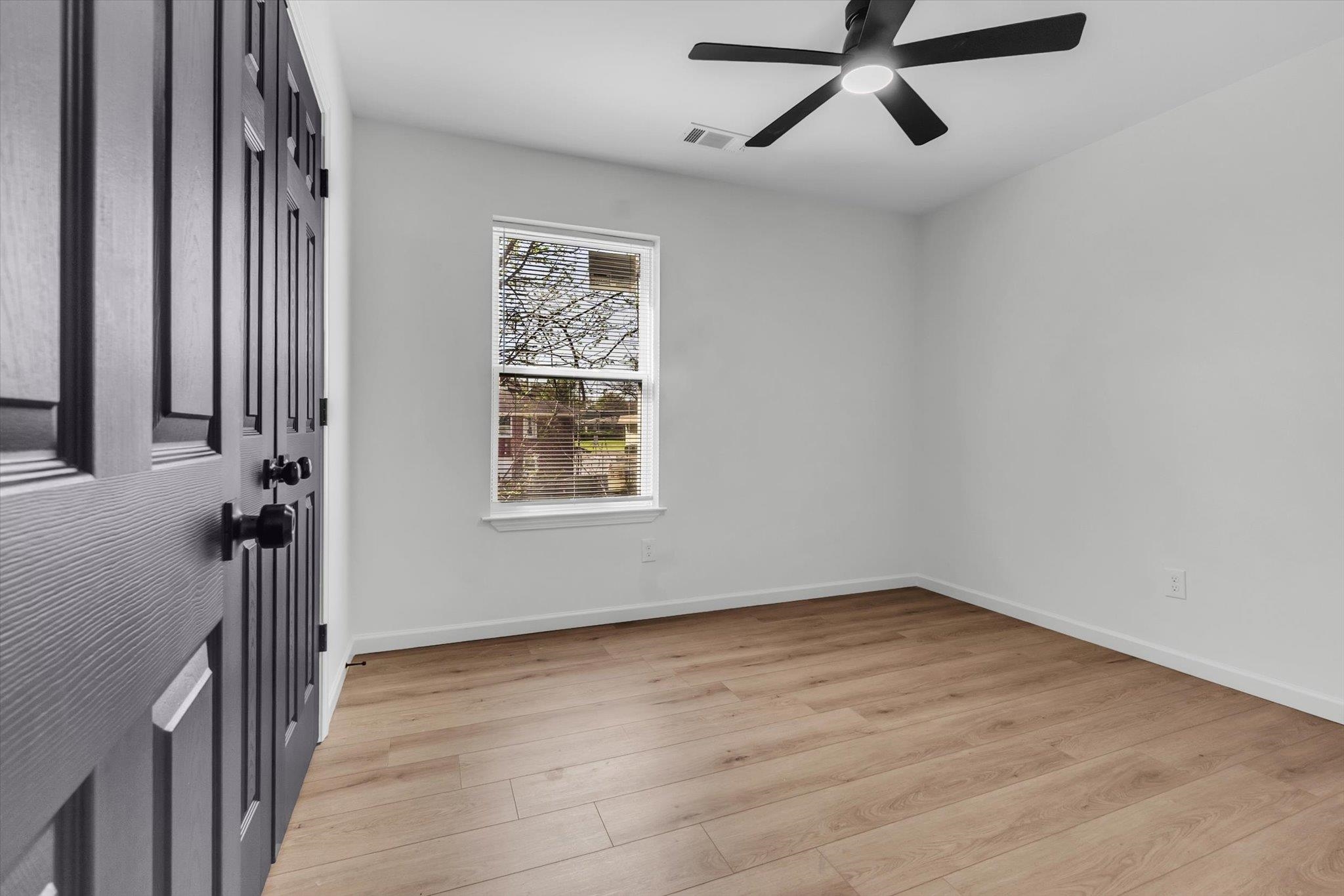 574 Lipford Street Memphis, TN 38112 - Photo 16 of 26 wooden floor in an empty room with a window